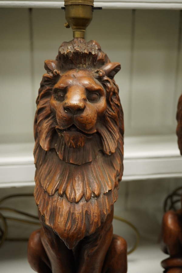A pair of Thomas Blakemore faux oak 'lion' lamp bases, 47cm high overall. Condition - some minor chips